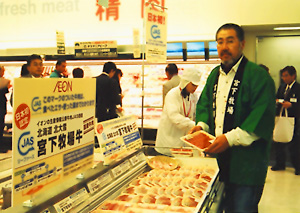 JASマークのついたジャスコの新商品「生産情報公表牛肉」を手にした生産者の宮下盛次さん=ジャスコ品川シーサイド店の牛肉売場。