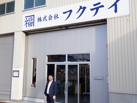 社屋の前に立つ株式会社フクテイの福島英一社長（青森県弘前市）