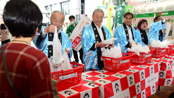 新米「きぬむすめ」を配る役員ら