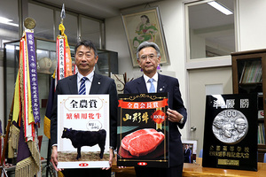 繁殖用種雄牛と牛肉を贈る山崎専務（右）