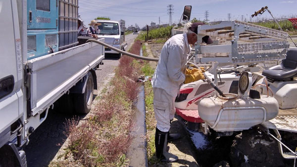 ペーストチャージャーで軽トラから直接肥料補給している様子